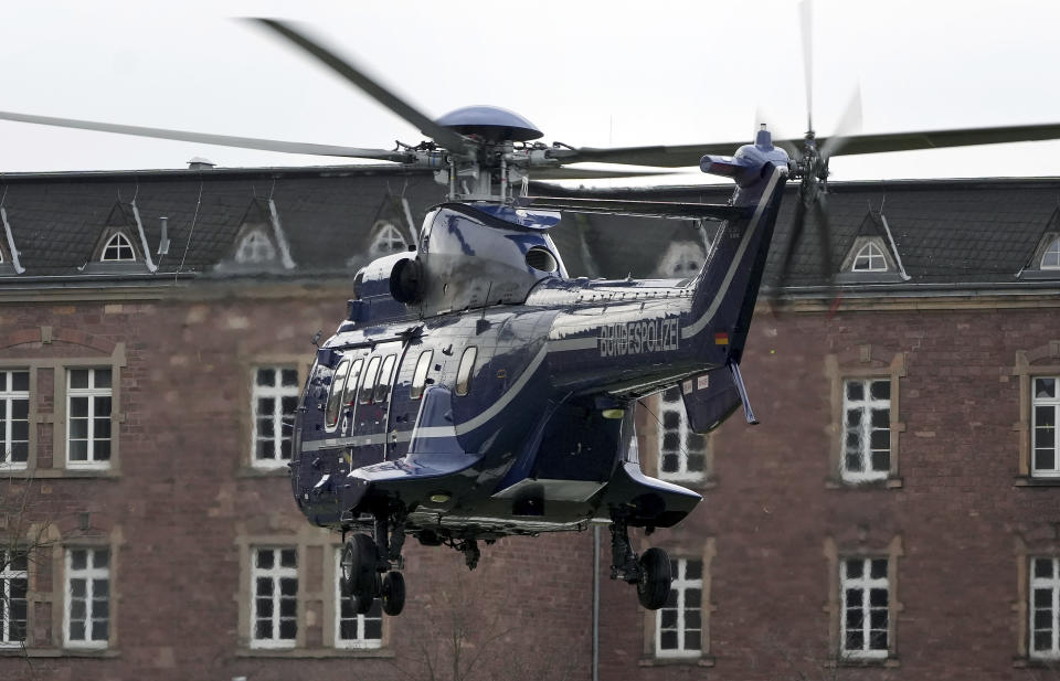 A police helicopter with a suspect arrives in Karlsruhe, Germany, Wednesday, Dec. 7, 2022 close the federal prosecutor's office. Thousands of police officers carried out raids across much of Germany on Wednesday against suspected far-right extremists who allegedly sought to overthrow the government in an armed coup. Officials said 25 people were detained. (AP Photo/Michael Probst)