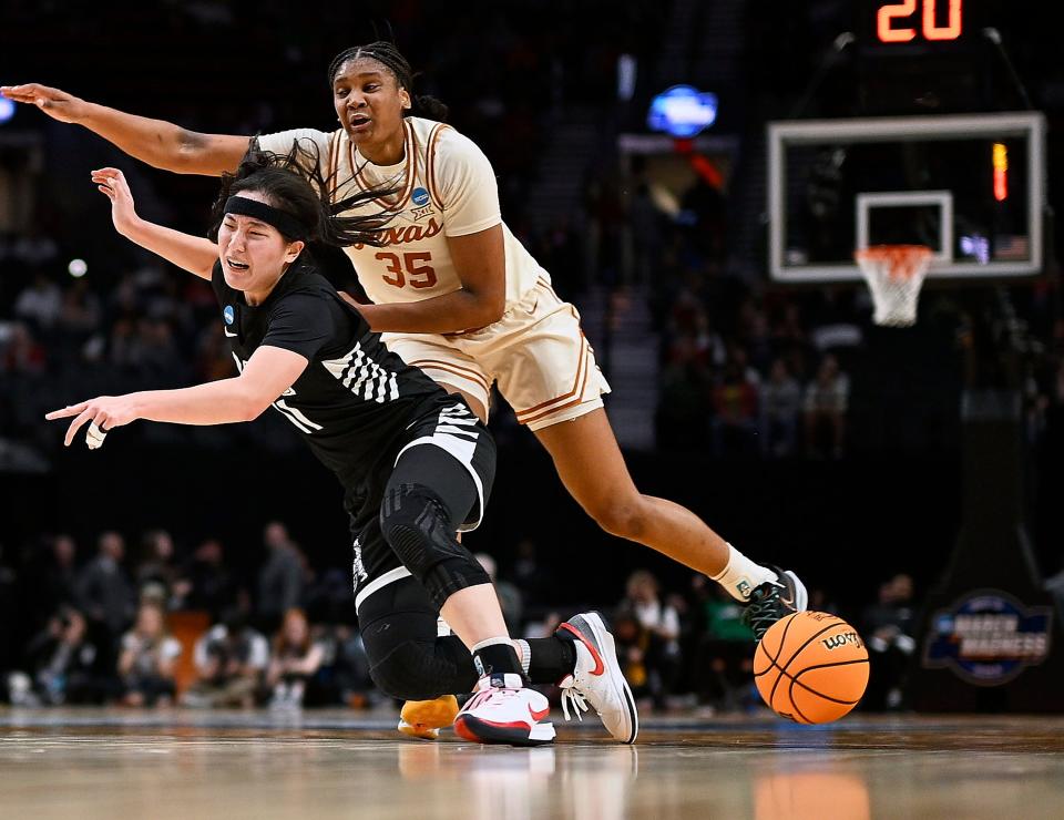 Texas point guard Madison Booker crashes into Gonzaga guard Kayleigh Truong during the second half of the Longhorns' 69-47 win in the Sweet 16 at the Moda Center in Portland, Ore. Booker and Truong were AAU teammates in high school. The Longhorns will next face North Carolina State in Sunday's Elite Eight.