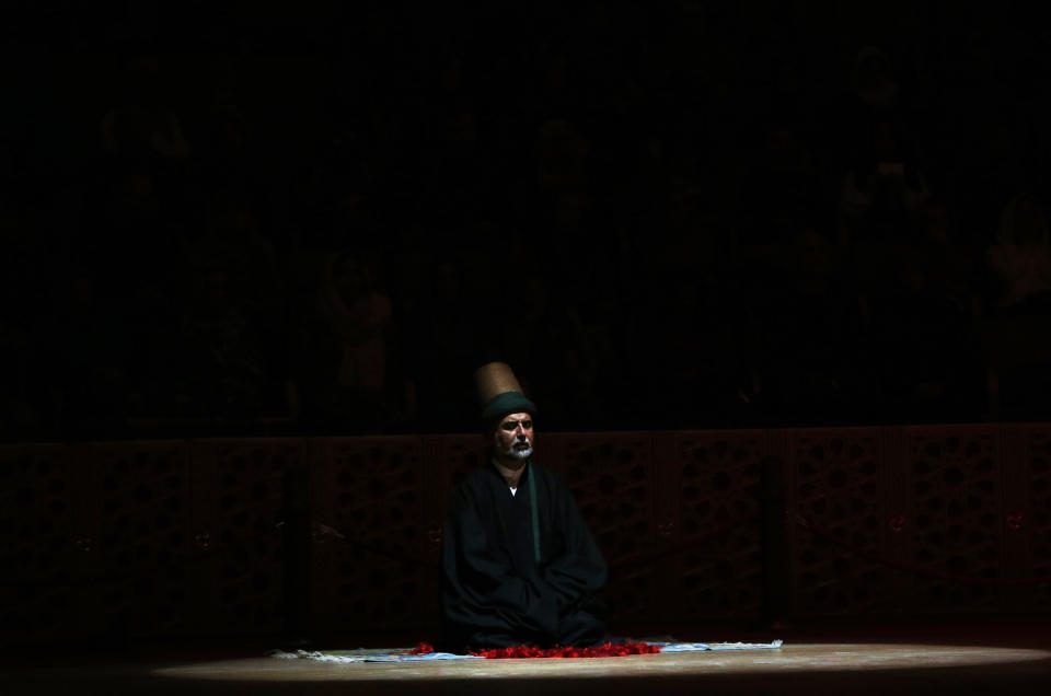 In this photo taken on Sunday, Dec. 16, 2018, a sheikh of the Mevlevi order of whirling dervishes offers his prayers during a Sheb-i Arus ceremony in Konya, central Turkey. Every December the Anatolian city hosts a series of events to commemorate the death of 13th century Islamic scholar, poet and Sufi mystic Jalaladdin Rumi. (AP Photo/Lefteris Pitarakis)