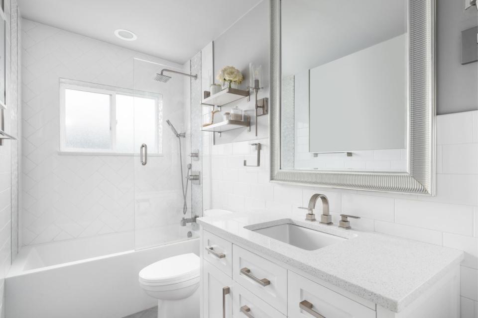 This photos shows a bright white bathroom.