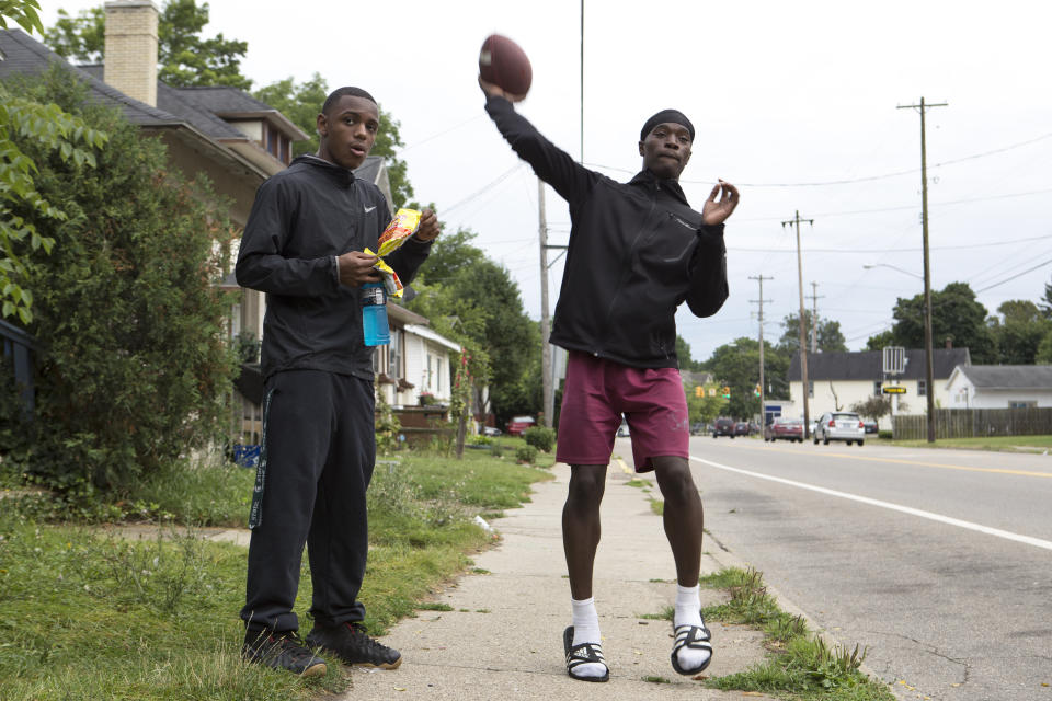 Jones tosses a football while hanging out with his friends in front of his home. (Photo: Casey Sykes for HuffPost)