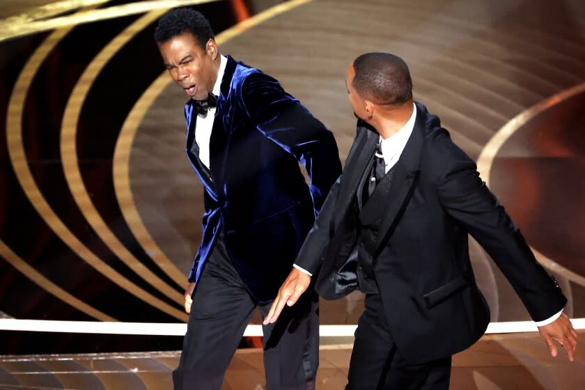 HOLLYWOOD, CA - March 27, 2022. Chris Rock and Will Smith onstage during the show at the 94th Academy Awards at the Dolby Theatre at Ovation Hollywood on Sunday, March 27, 2022. (Myung Chun / Los Angeles Times)