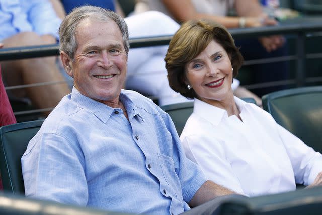 Mike Stone/Getty Images George W. Bush and Laura Bush attend a sporting event together