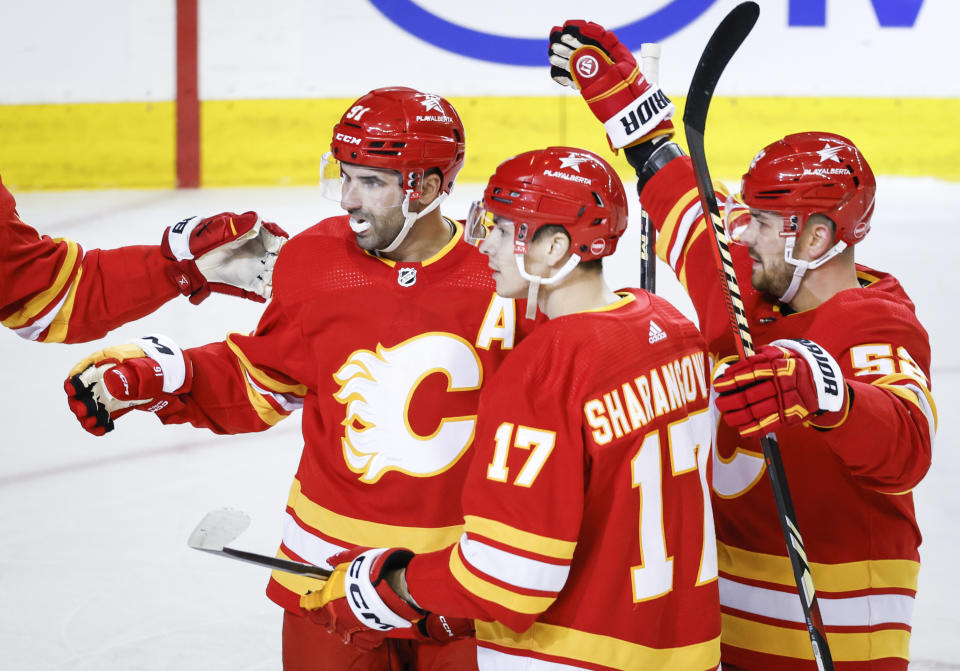 Calgary Flames forward Nazem Kadri (91) celebrates his goal against the Los Angeles Kings with teammates during the first period of an NHL hockey game Saturday, March 30, 2024, in Calgary, Alberta. (Jeff McIntosh/The Canadian Press via AP)