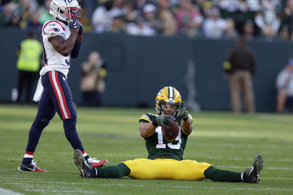 Green Bay Packers wide receiver Allen Lazard (13) celebrates ahead of New England Patriots cornerback Jonathan Jones, left, after catching a pass during the second half of an NFL football game, Sunday, Oct. 2, 2022, in Green Bay, Wis. (AP Photo/Matt Ludtke)