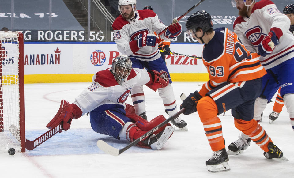 Edmonton Oilers' Ryan Nugent-Hopkins (93) is stopped by Montreal Canadiens goalie Carey Price (31) during second-period NHL hockey game action in Edmonton, Alberta, Saturday, Jan. 16, 2021. (Jason Franson/The Canadian Press via AP)