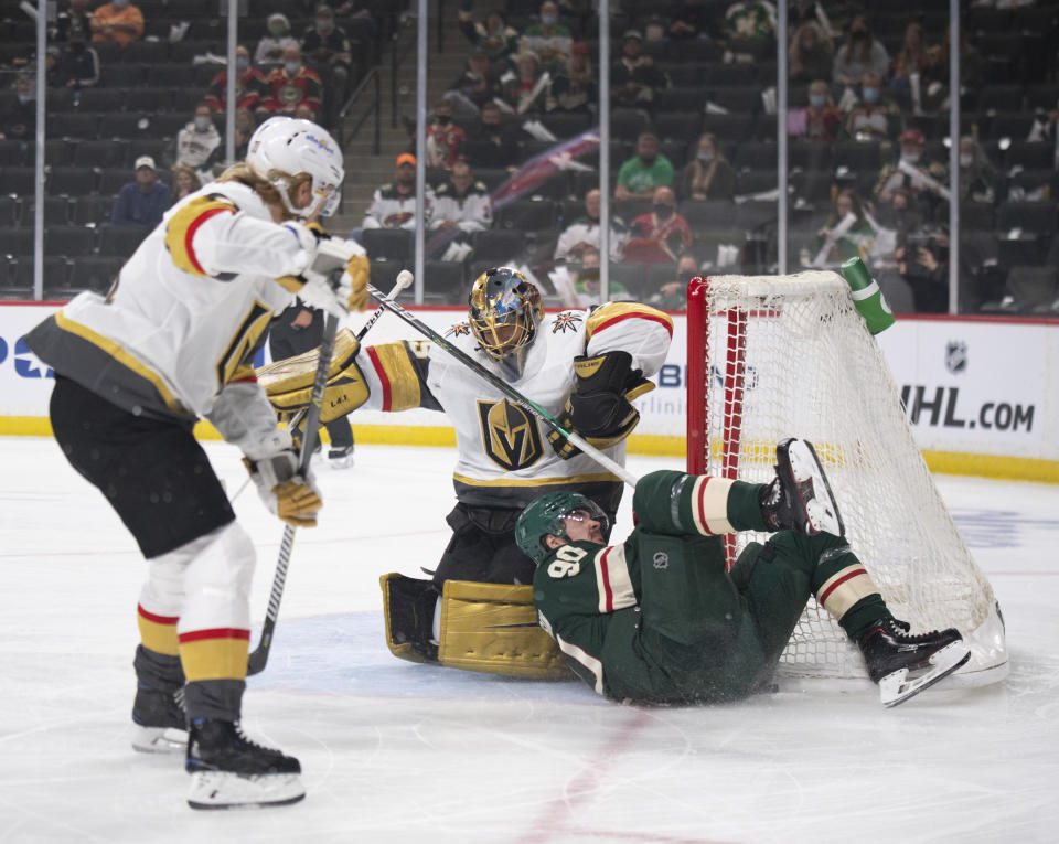 Minnesota Wild center Marcus Johansson (90) crashes against the net and Vegas Golden Knights goaltender Marc-Andre Fleury (29) during the first period in Game 3 of an NHL hockey first-round playoff series Thursday, May 20, 2021, in St. Paul, Minn. (Jeff Wheeler/Star Tribune via AP)