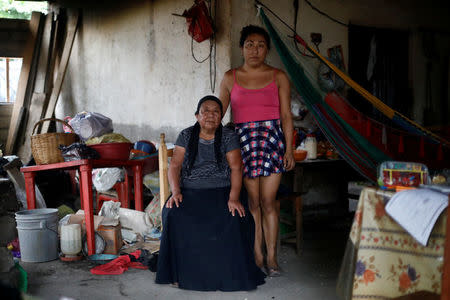 Ximena, 26, an indigenous Zapotec transgender woman also know as Muxe, pose for a photo next her mother inside her house destroyed after an earthquake that struck on the southern coast of Mexico late on Thursday, in Juchitan, Mexico, September 10, 2017. REUTERS/Edgard Garrido