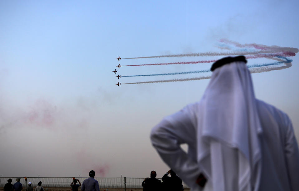 An Emirati visitor watches the Al Fursan, the aerobatics demonstration team of the UAE Air Force during the Dubai Airshow in Dubai, United Arab Emirates, Monday Nov. 18, 2013. (AP Photo/Kamran Jebreili)