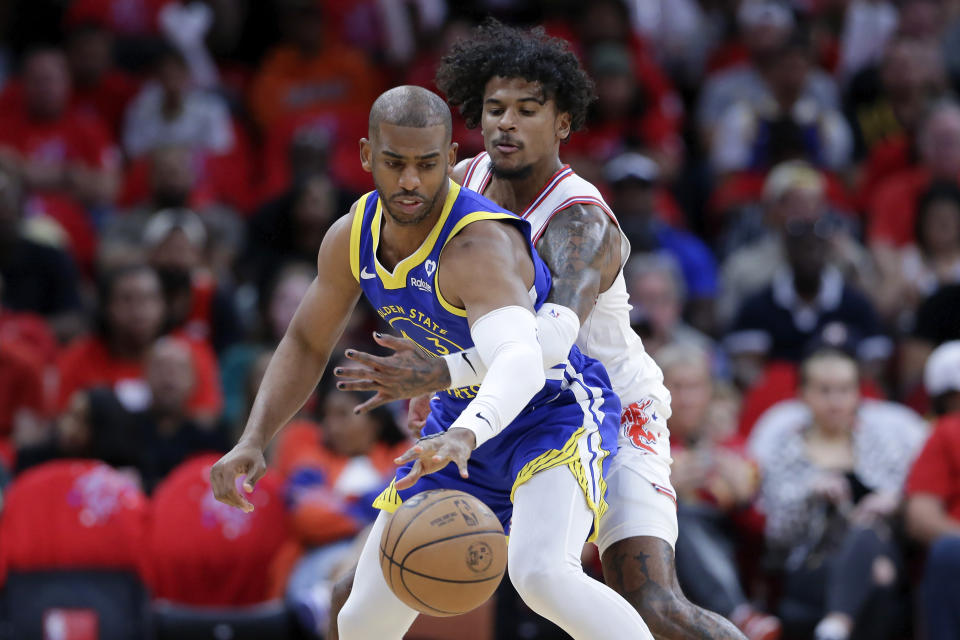 Golden State Warriors guard Chris Paul, left, has the ball knocked away by Houston Rockets guard Jalen Green during the first half of an NBA basketball game Thursday, April 4, 2024, in Houston. (AP Photo/Michael Wyke)
