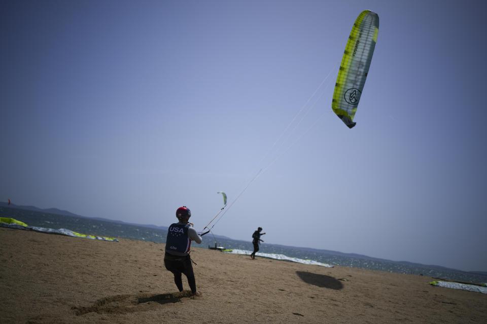 FILE - U.S. Olympic sailing team member Daniela Moroz prepares for a kiteboarding session in Hyeres, southern France, Monday, April 29, 2024. The fastest sport at the Paris Games has such wild speeds that the athletes say the waves and the wind become muted. (AP Photo/Daniel Cole, File)