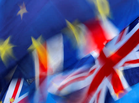 FILE PHOTO: British and EU flags flutter outside the Houses of Parliament during a pro-Brexit and anti-Brexit demonstration, ahead of a vote on Prime Minister Theresa May's Brexit deal, in London, Britain, January 15, 2019. REUTERS/Eddie Keogh/File Photo