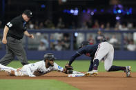 Atlanta Braves second baseman Ozzie Albies (1) tags Miami Marlins' Bryan De La Cruz (14) as he tried to stay on the base during the seventh inning of a baseball game, Tuesday, May 2, 2023, in Miami. (AP Photo/Marta Lavandier)