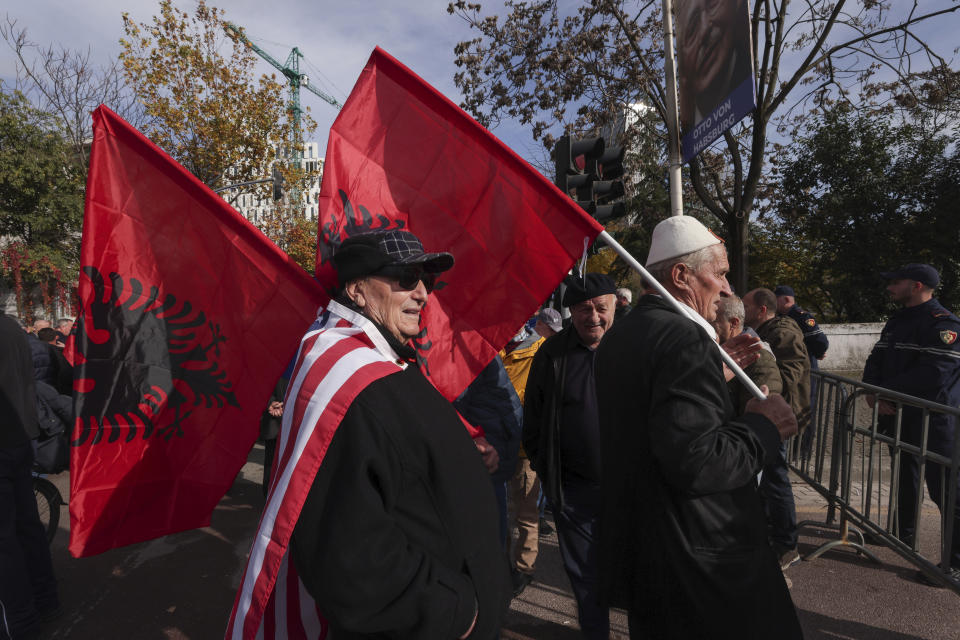 People hold Albanian flags as they take part in an an anti-government protest held near a summit of European Union leaders and their counterparts from the Western Balkans in the capital Tirana, Albania , on Tuesday, Dec. 6, 2022. Sali Berisha, a 78-year-old former president , prime minister and the leader of the Albanian opposition center-right Democratic Party has been attacked during protest when a man came out of the crowd and punched him in the face. The opposition was protesting against alleged corruption by Prime Minister Edi Rama, which they blame for the country's cost-of-living crisis.(AP Photo/Franc Zhurda)