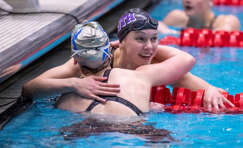 Bloomington South High School’s Kristina Paegle, right, celebrates with Carmel High School’s Gretchen Lueking after the two competed in the 100 Yard Freestyle event during the 2022 Girls’ Swimming & Diving State Tournament, Saturday, Feb. 12, 2022, at Indiana University Natatorium in Indianapolis.
