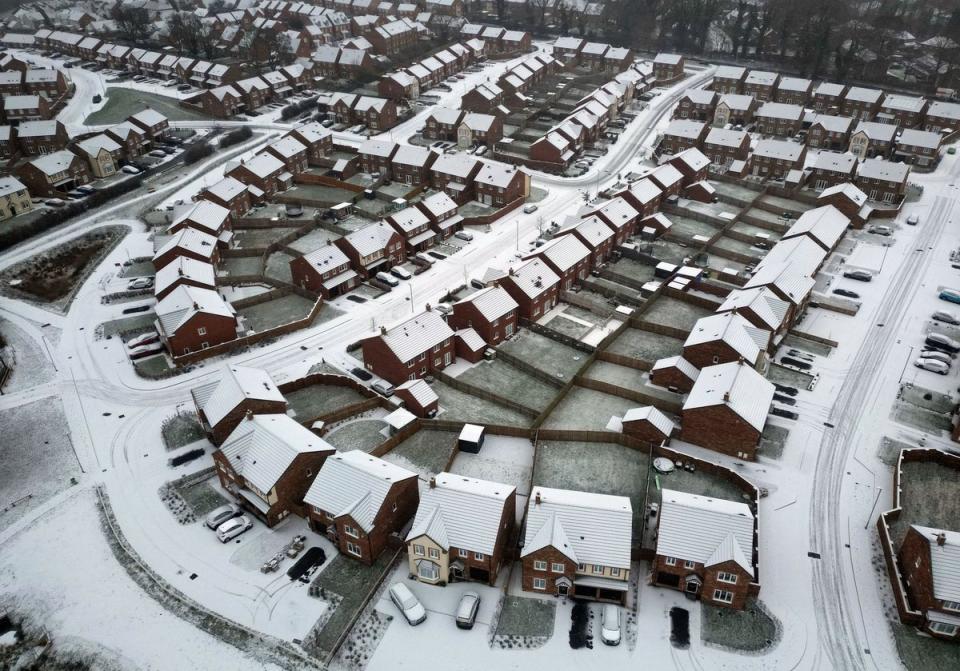 Snow covered rooftops near Carlisle in Cumbria (PA)