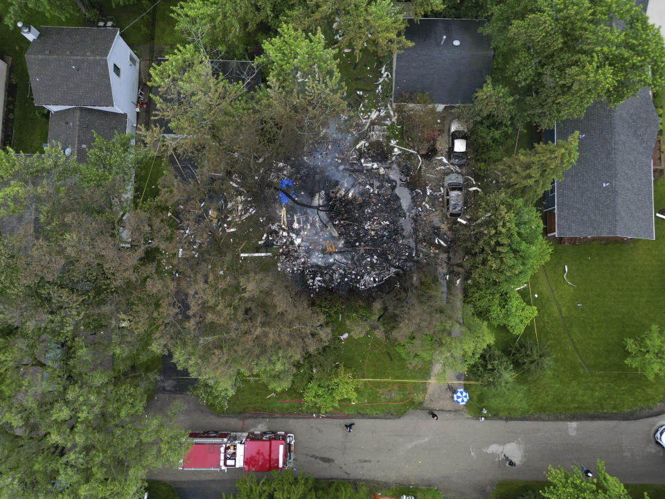 Smoke still rises from the aftermath of a home explosion in unincorporated Lake Zurich, Ill., Wednesday, June 5, 2024. First responders found the home leveled after an explosion about 8:30 p.m. Tuesday according to the Lake County sheriff's office. (Stacey Wescott/Chicago Tribune via AP)