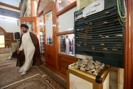 Pieces of molded clay made of local soil, known as ''turba,'' are seen at a mosque in Najaf, Iraq April 3, 2018. Picture taken April 3, 2018. REUTERS/Alaa Al-Marjani