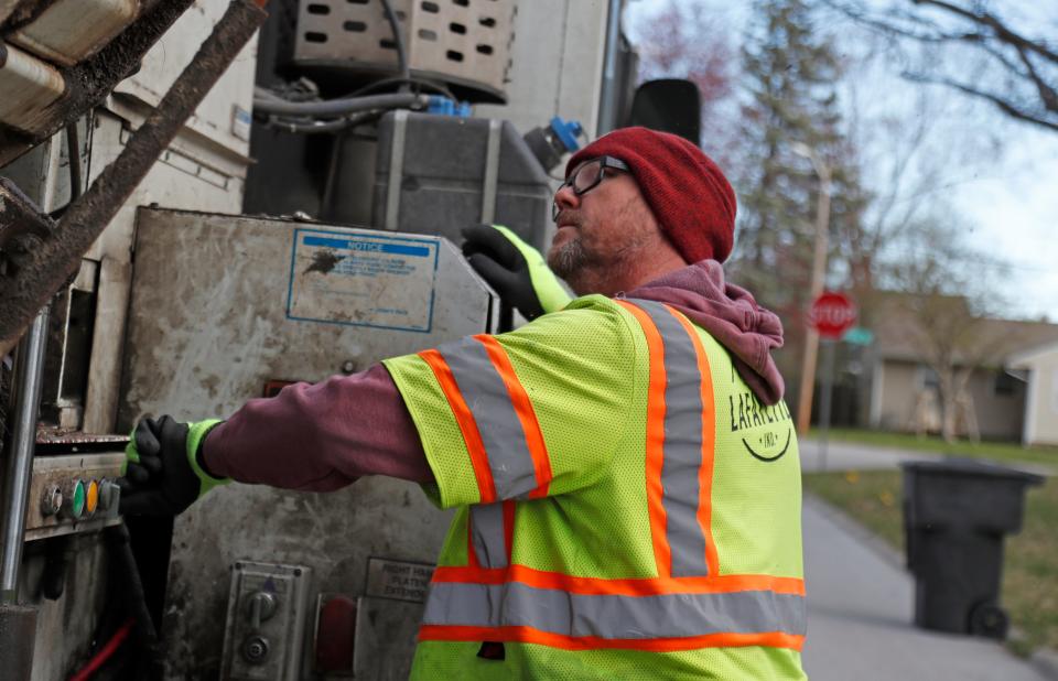 Wayne Coddington loads up a trashcan, Wednesday, March 20, 2024, Lafayette, Ind.