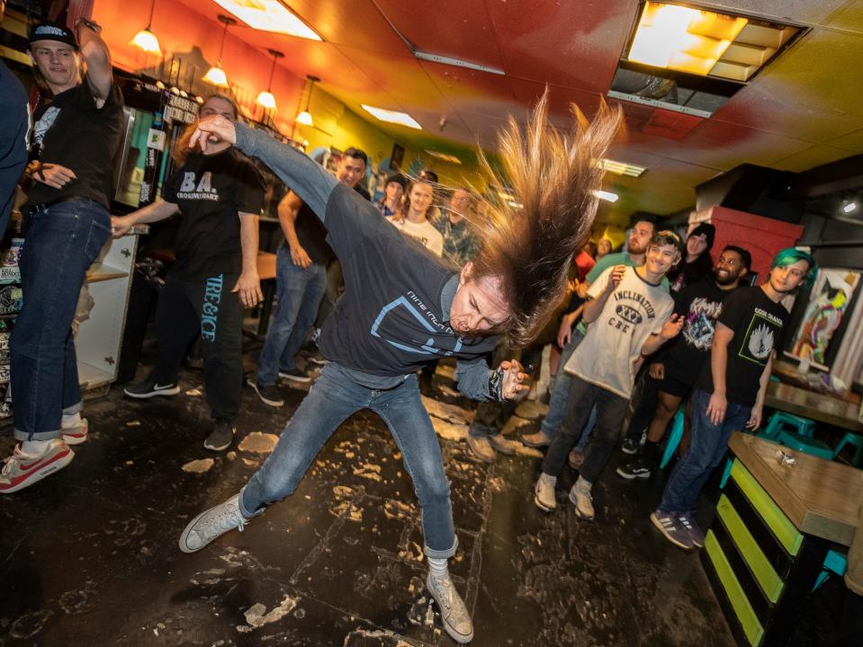 A young man slam dances to  straight edge and hardcore punk music at Spinelli's Pizza in downtown Louisville. Oct. 24, 2019.