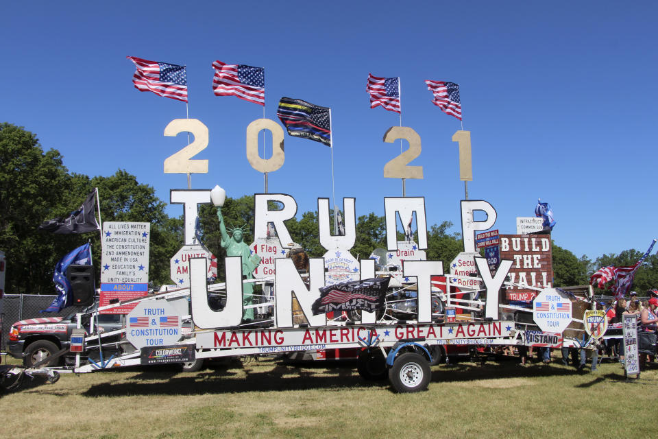 A display on a trailer is parked at a rally organized by pillow salesman-turned conspiracy peddler Mike Lindell in New Richmond, Wis., on Saturday, June 12, 2021. Talk of former President Donald Trump being reinstated, even though there is no legal or Constitutional mechanism for that happening, was common at the weekend MAGA rally in western Wisconsin. (AP Photo/Jill Colvin)