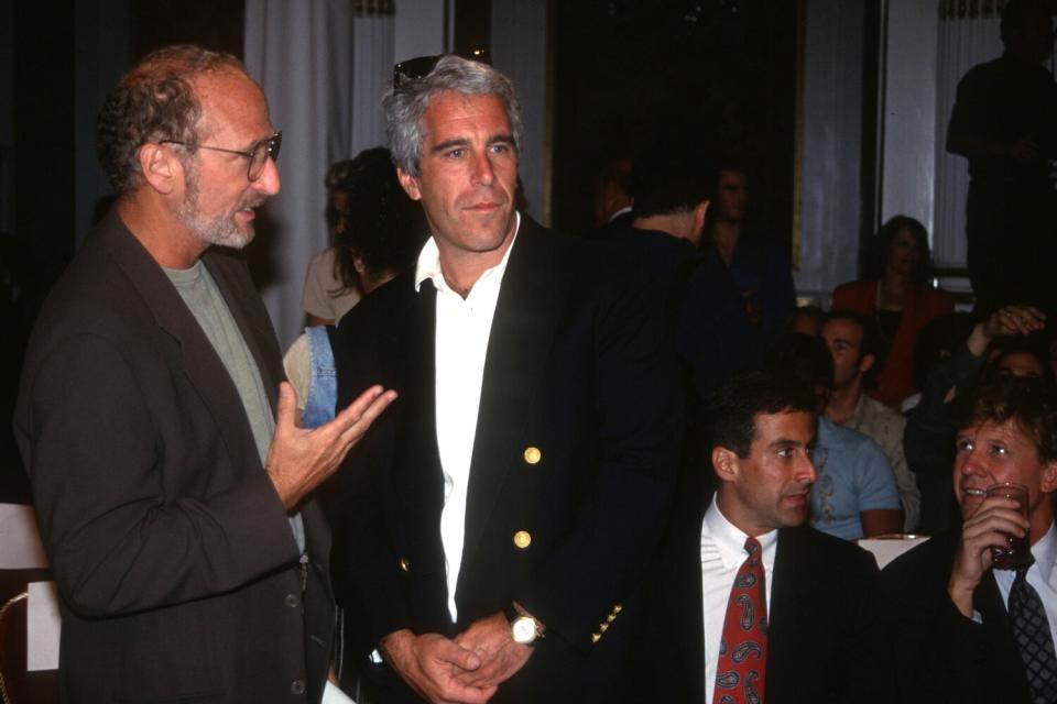 Two men talk at a fashion show