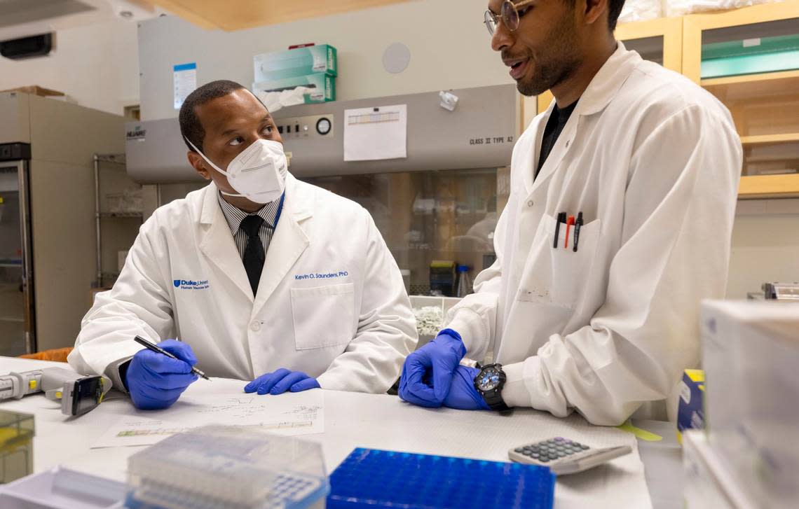 Dilshan Malewana, right, a PhD candidate in immunology, talks with Kevin O. Saunders, PhD, Director of Research for the Duke Human Vaccine Institute about his research on Wednesday, July 13, 2022 in Durham, N.C.