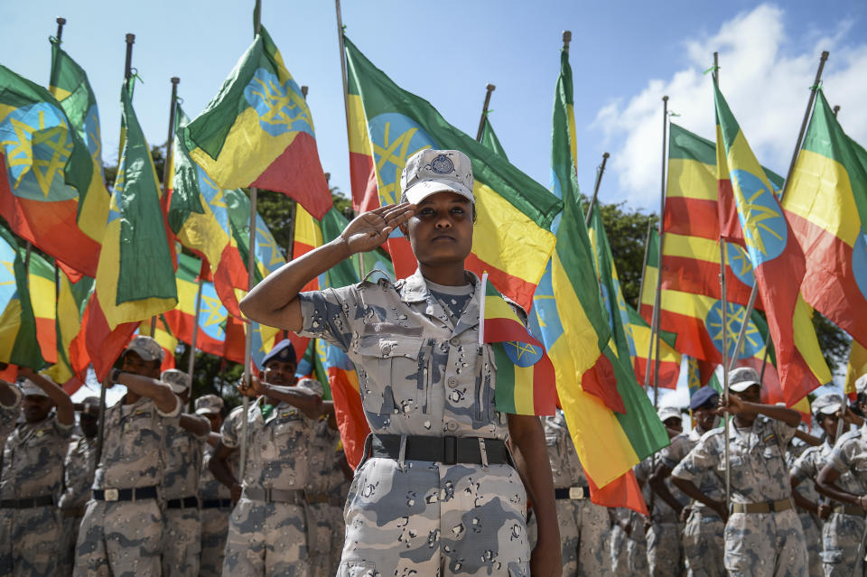 Members of the Ethiopian National Defense Force hold national flags as they parade during a ceremony to remember those soldiers who died on the first day of the Tigray conflict, outside the city administration office in Addis Ababa, Ethiopia Thursday, Nov. 3, 2022. Ethiopia's warring sides agreed Wednesday to a permanent cessation of hostilities in a conflict believed to have killed hundreds of thousands, but enormous challenges lie ahead, including getting all parties to lay down arms or withdraw. (AP Photo)