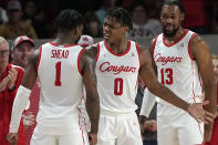 Houston's Marcus Sasser (0) celebrates with Jamal Shead (1) after making a basket while being fouled during the second half of an NCAA college basketball game against the South Florida Wednesday, Jan. 11, 2023, in Houston. Houston won 83-77. (AP Photo/David J. Phillip)