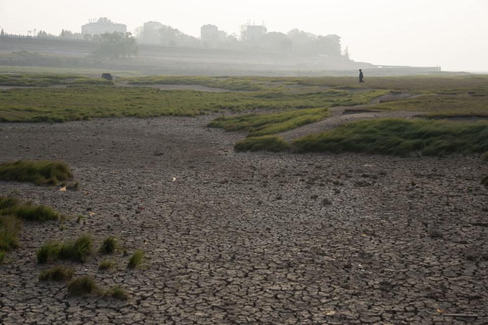 FILE - The cracked bed of the Poyang Lake is exposed during drought season in north-central China's Jiangxi province on Tuesday, Nov. 1, 2022. A prolonged drought since July has dramatically shrunk China's biggest freshwater lake, Poyang. (AP Photo/Ng Han Guan, File)