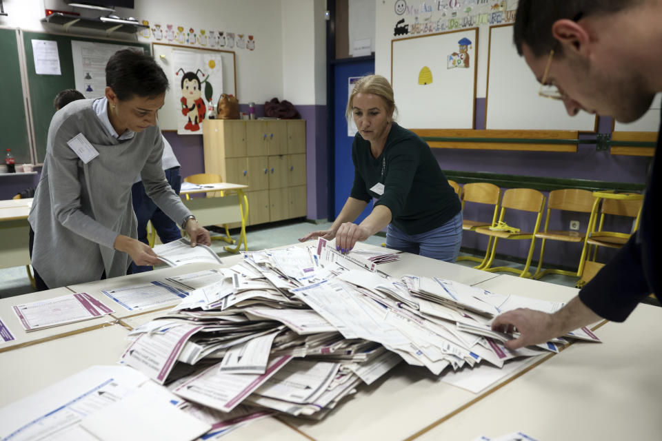 Election Commission officials count votes after general election in Sarajevo, Bosnia, Sunday, Oct. 2, 2022. Polls opened Sunday in Bosnia for a general election that is unlikely to bring any structural change despite palpable disappointment in the small, ethnically divided Balkan country with the long-established cast of sectarian political leaders. (AP Photo/Armin Durgut)