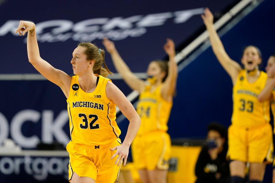 Michigan guard Leigha Brown (32) and teammates react after Brown's three-point basket during the second half of an NCAA college basketball game against Michigan State, Tuesday, Feb. 16, 2021, in Ann Arbor, Mich. (AP Photo/Carlos Osorio)