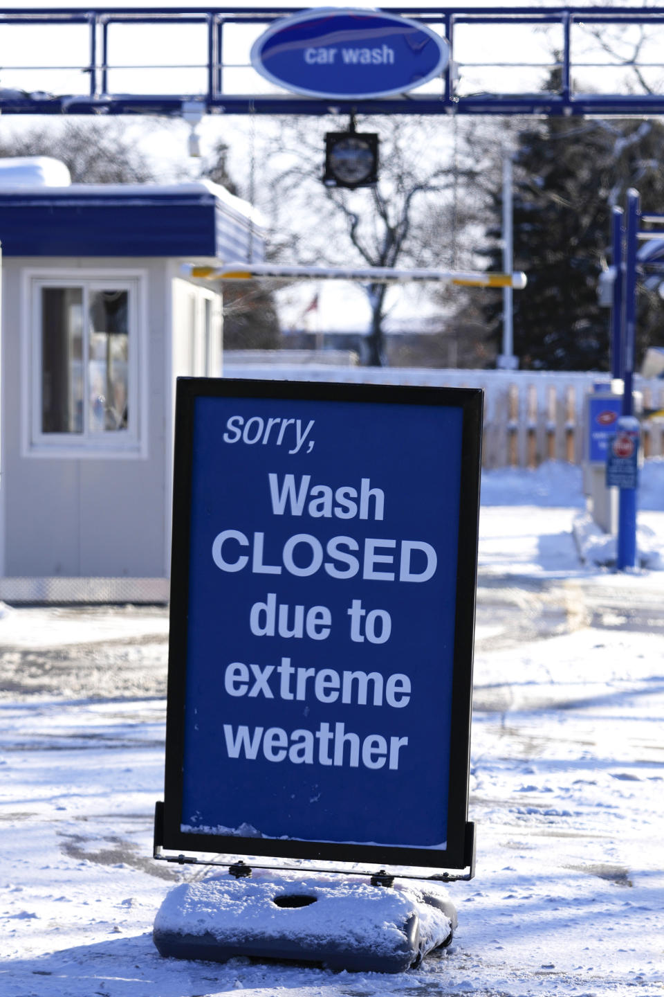 An information sign is displayed at a car wash center in Palatine, Ill., Sunday, Jan. 14, 2024. Wind chill warning is in effect as dangerous cold conditions continue in the Chicago area. (AP Photo/Nam Y. Huh)