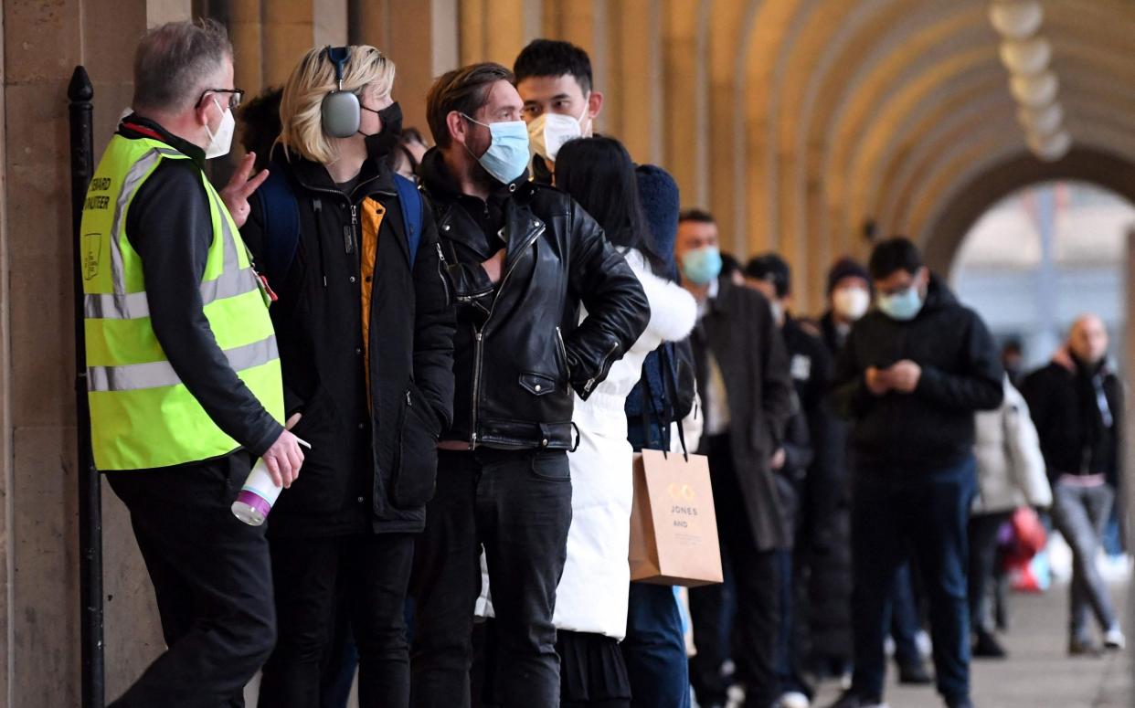 The queue for the booster vaccine outside Manchester Town Hall yesterday - PAUL ELLIS/AFP via Getty Images