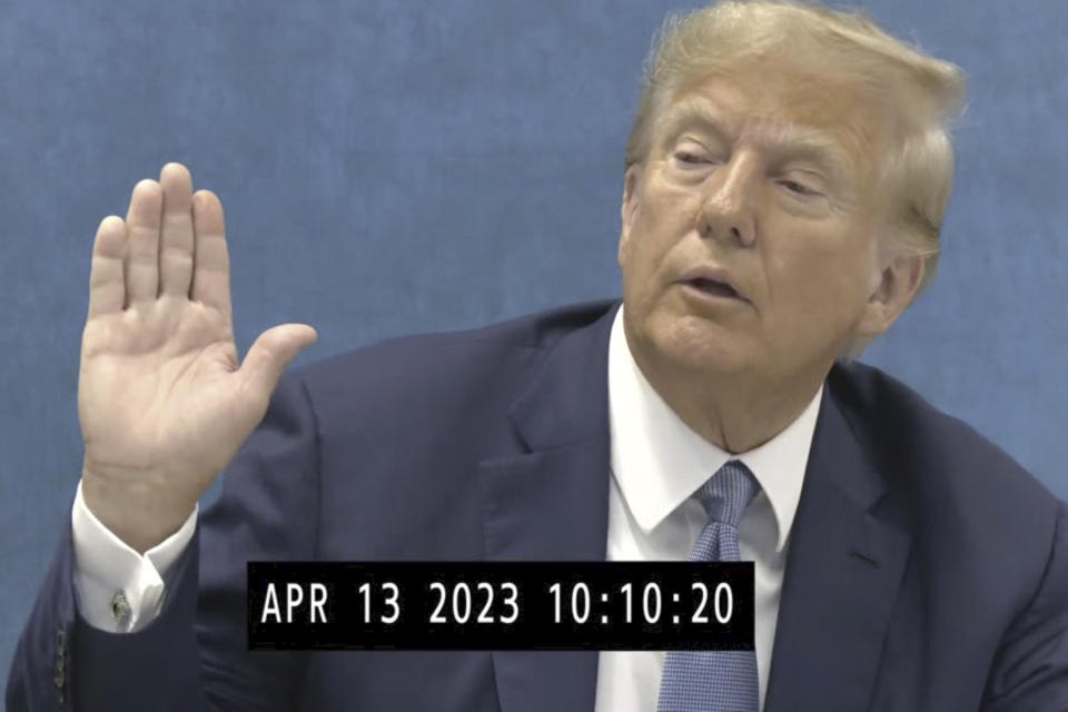 In this image taken from from video made public by the Office of the New York State Attorney General on Friday, Jan. 19, 2024, former President Donald Trump is sworn in for a deposition on April, 13, 2023, where the former president came face-to-face with the New York State Attorney General Letitia James at her Manhattan, New York Office. (Office of the New York State Attorney General via AP)