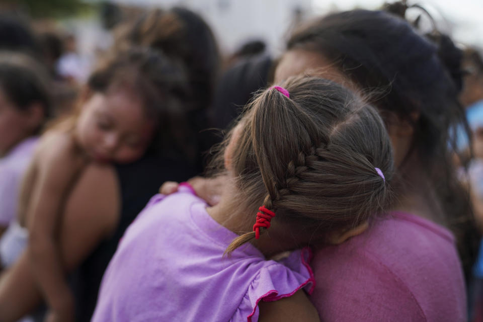 In this Aug. 30, 2019, photo, migrants, many who were returned to Mexico under the Trump administration’s “Remain in Mexico” program, wait in line to get a meal in an encampment near the Gateway International Bridge in Matamoros, Mexico. The program, officially called the Migrant Protection Protocols, was instituted by the U.S. and Mexico as a way of deterring migrants from crossing the border to seek asylum. (AP Photo/Veronica G. Cardenas)