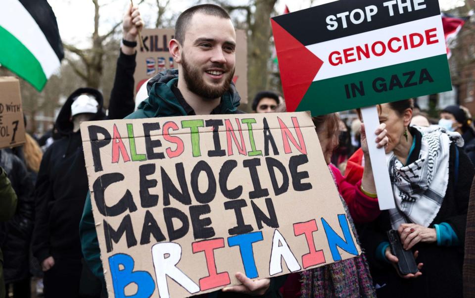 Protesters at a march in London carry banners accusing Israel of genocide in Gaza