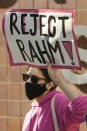 Danaka Katovich of Code Pink, holds a sign during a rally to protest former Chicago Mayor Rahm Emanuel's appointment as ambassador to Japan outside the Chicago Police Headquarters Tuesday, Oct. 19, 2021, in Chicago. The fatal police shooting of a Black teen in Chicago seven years ago is looming large over the city’s former mayor, Emanuel, as he looks to win confirmation as President Joe Biden’s ambassador to Japan. (AP Photo/Paul Beaty)