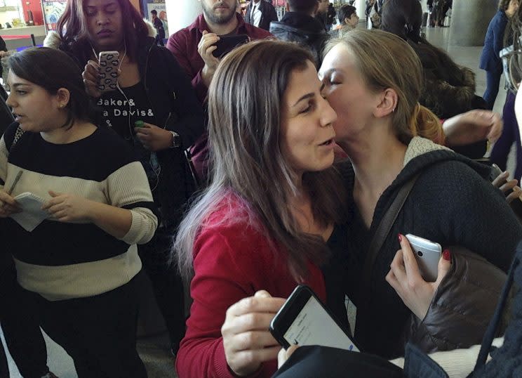 Vahideh Rasekhi, an Iranian doctoral student at Stony Brook University, greets friends and family as she is released from detention at John F. Kennedy International Airport in New York on Sunday. (Photo: Seth Wenig/AP)