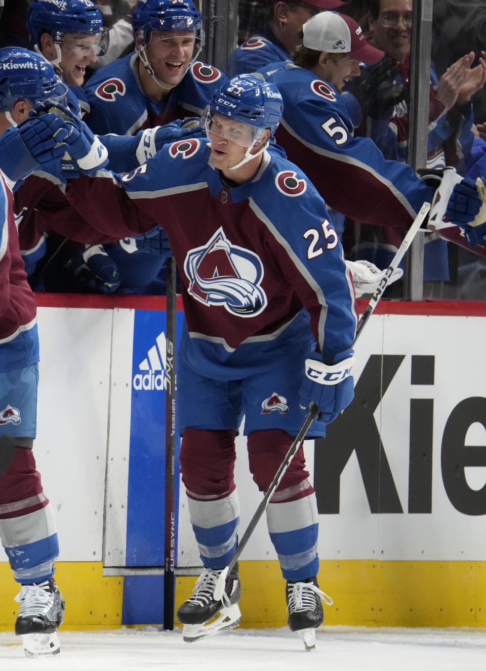 Colorado Avalanche right wing Logan O'Connor (25) is congratulated as he passes the team box after scoring a short-handed goal against the Carolina Hurricanes in the second period of an NHL hockey game Saturday, Oct. 21, 2023, in Denver. (AP Photo/David Zalubowski)
