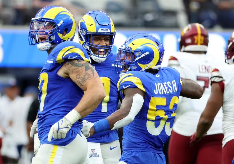 Rams Ernest Jones IV (53), Michael Hecht, left, and Kobe Turner celebrate.