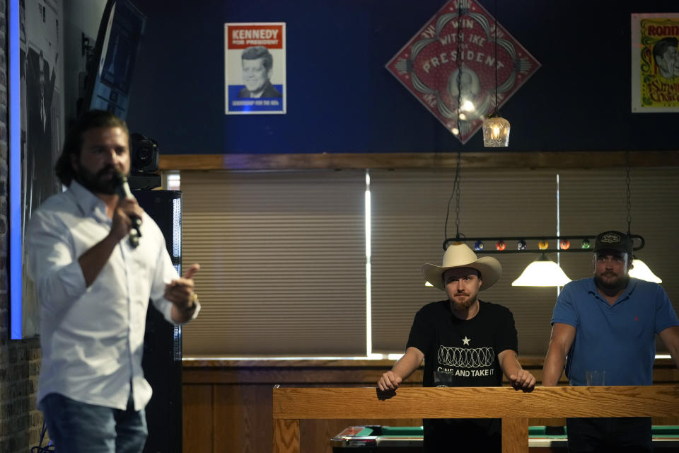 Brandon Herrera, left, a gun-rights YouTube creator who calls himself "The AK Guy", speaks during a campaign stop, Thursday, May 23, 2024, in San Antonio. Herrera is facing prominent Republican incumbent U.S. Rep. Tony Gonzales in a runoff election. (AP Photo/Eric Gay)