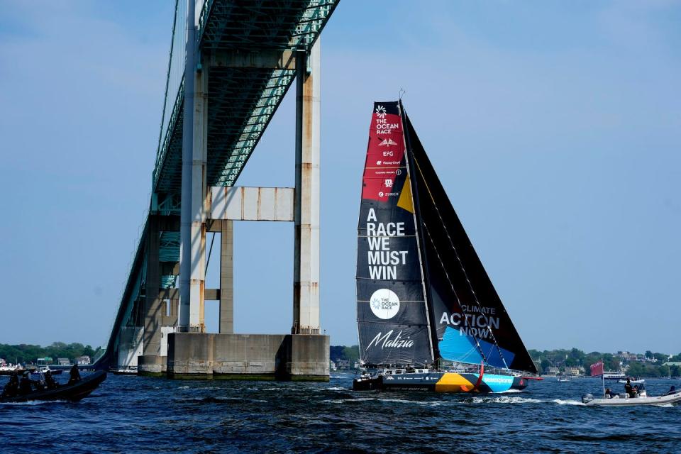 Team Malizia sailing under the Newport Bridge.