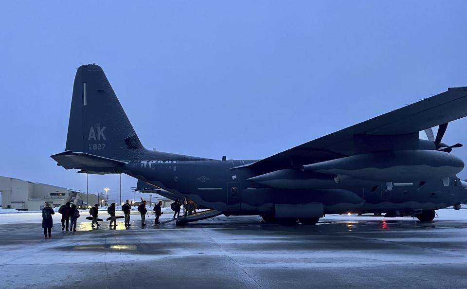 This March 28, 2023, photo shows Alaska National Guard personnel loading on to an HC-130J Combat King II at Joint Base Elemendorf-Richardson, Alaska, for a flight to Gambell, Alaska, for a medal ceremony. Sixteen Alaska National Guard members were honored for helping rescue the 11 crewmembers of a Navy plane that was shot down in 1955 by Soviet jet fighters and crash-landed about 8 miles from Gambell, on St. Lawrence Island, and 15 medals were presented posthumously. (AP Photo/Mark Thiessen)