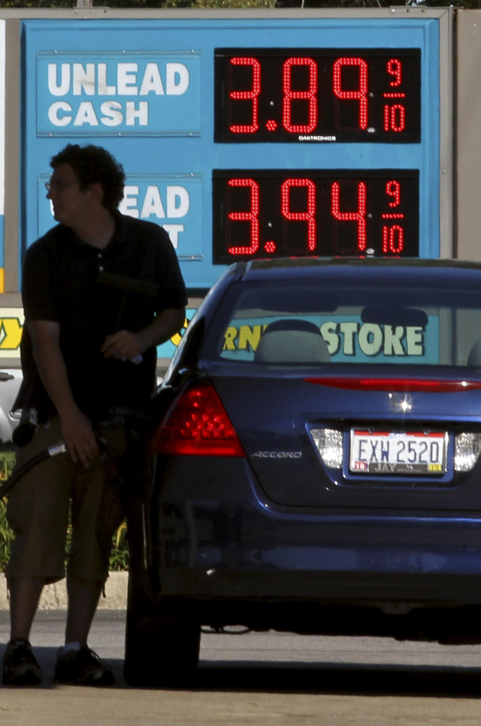 A man fills his gas tank at a gas station Wednesday, Aug. 29, 2012, in Lyndhurst, Ohio. Drivers are facing the biggest one-day jump in gasoline prices in 18 months as Hurricane Isaac swamps the nation’s oil and gas hub along the Gulf Coast. Some states in the Midwest suffered even more dramatic spikes. Ohio prices jumped 14 cents, Indiana prices jumped 13 cents and Illinois prices jumped 10 cents according to the Oil Price Information Service. (AP Photo/Tony Dejak)