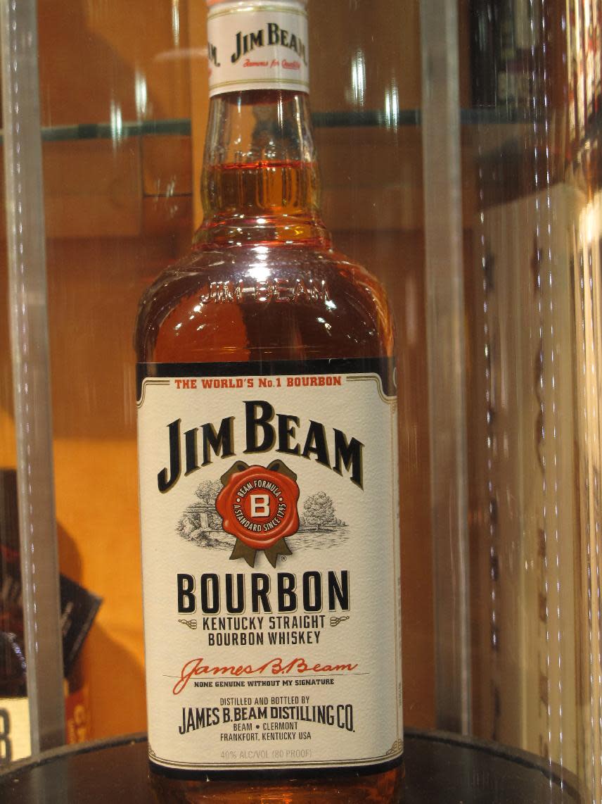 In this Monday, Jan. 13, 2014, photo, a Jim Beam bourbon bottle is on display at the Jim Beam visitors’ center at Clermont, Ky. The bourbon brands will be acquired by Japanese-based Suntory Holdings Ltd. as part of its planned $13.6 billion acquisition of Beam Inc. Whiskey insiders say Kentucky bourbon still ranks as authentically American, even when some of its distillers answer to foreign companies. (AP Photo/Bruce Schreiner)