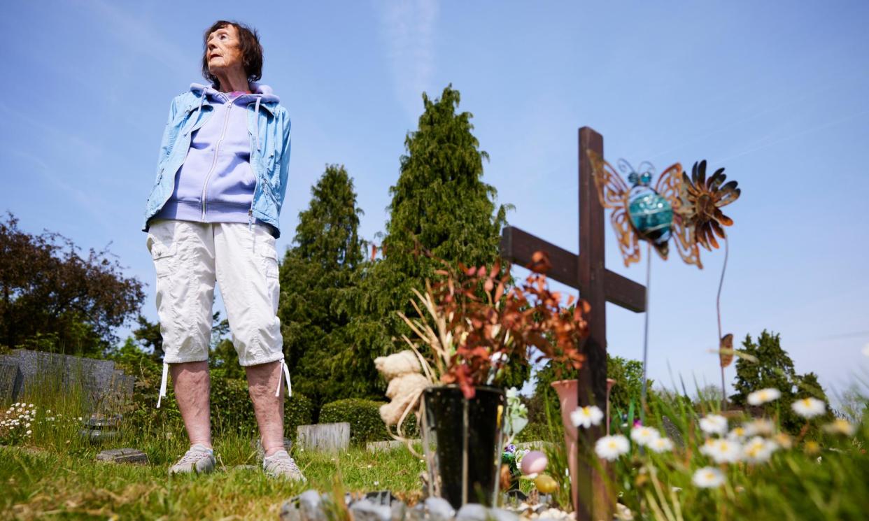 <span>Gina Jacobs at Landican cemetery where her son Robert was buried after he was stillborn in 1969.</span><span>Photograph: Christopher Thomond/The Guardian</span>