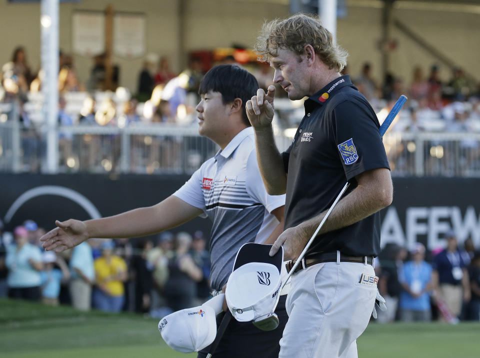 Brendt Snedeker, right, and Sungjae Im, left, of South Korea, walk off the 18th green of the Silverado Resort North Course after finishing the final round of the Safeway Open PGA golf tournament Sunday, Oct. 7, 2018, in Napa, Calif. Kevin Tway won the tournament on the third playoff hole. (AP Photo/Eric Risberg)