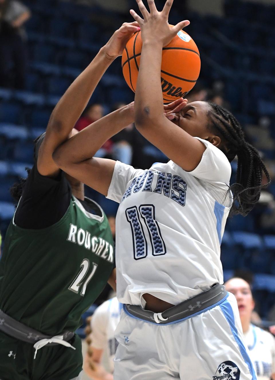 Bartlesville High School's Candence Gray (11) fights for a rebound with a Muskogee player during basketball action in Bartlesville on Feb. 5, 2024.