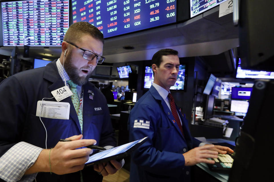 Trader Ryan Falvey, left and specialist John McNierney work on the floor of the New York Stock Exchange, Tuesday, Nov. 12, 2019. Stocks are opening slightly higher on Wall Street, led by gains in technology and health care companies. (AP Photo/Richard Drew)